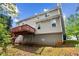 Back of the house with gray siding, a wooden deck, and stairs leading to the yard at 531 Chadborn Ct, Lawrenceville, GA 30045