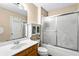 Bathroom with a wood vanity, matching medicine cabinet and shower with sliding glass doors at 531 Chadborn Ct, Lawrenceville, GA 30045