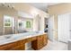 Bathroom featuring double sinks, wooden cabinets, and a large mirror at 531 Chadborn Ct, Lawrenceville, GA 30045