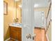 Half bath with a wood vanity, framed mirror, and decorative lighting at 531 Chadborn Ct, Lawrenceville, GA 30045