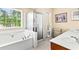 Bright bathroom featuring a soaking tub, glass-enclosed shower, and double sinks at 531 Chadborn Ct, Lawrenceville, GA 30045