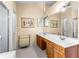 Bathroom featuring double sinks, wooden cabinets, and a large mirror at 531 Chadborn Ct, Lawrenceville, GA 30045