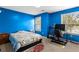 Bedroom featuring blue walls, carpet, and a bright window view at 531 Chadborn Ct, Lawrenceville, GA 30045