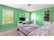 Bedroom featuring green walls, carpet flooring, two windows, and a closet door at 531 Chadborn Ct, Lawrenceville, GA 30045