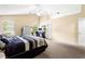 Bedroom with high ceilings, ceiling fan, and neutral colored carpet at 531 Chadborn Ct, Lawrenceville, GA 30045