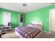 Bedroom featuring green walls, carpet flooring, and a window for natural light at 531 Chadborn Ct, Lawrenceville, GA 30045
