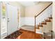 Beautiful entryway with wood floors, carpeted stairs, and adjacent paneled wainscoting at 531 Chadborn Ct, Lawrenceville, GA 30045