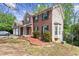 Side view of a brick home with vinyl siding, showing the two-car garage and landscaped garden bed at 531 Chadborn Ct, Lawrenceville, GA 30045