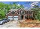 Two-story brick home with a two-car garage, a front porch, and manicured landscaping at 531 Chadborn Ct, Lawrenceville, GA 30045