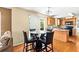 Well-lit dining area with seating for four, adjoining the kitchen with hardwood floors at 531 Chadborn Ct, Lawrenceville, GA 30045