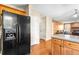 Well-equipped kitchen with black refrigerator and view to the living room with fireplace at 531 Chadborn Ct, Lawrenceville, GA 30045
