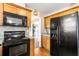 Cozy kitchen featuring wood cabinets and modern black appliances, including a refrigerator and microwave at 531 Chadborn Ct, Lawrenceville, GA 30045