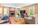 Cozy living room with a brick fireplace, large TV, and comfortable seating at 531 Chadborn Ct, Lawrenceville, GA 30045