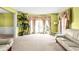 Airy living room with wall to wall carpet, large windows, and light green painted walls at 531 Chadborn Ct, Lawrenceville, GA 30045
