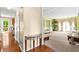 Spacious living room with hardwood floors, carpet, large windows, and decorative furniture at 531 Chadborn Ct, Lawrenceville, GA 30045