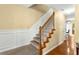 Staircase with carpet treads, wood trim and white risers at 531 Chadborn Ct, Lawrenceville, GA 30045