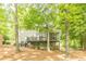 Exterior backyard view showing a deck, screened porch, and wooded landscape at 4314 Arbor Bridge Ct, Marietta, GA 30066