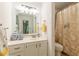 Well-lit bathroom featuring a vanity and shower with decorative floral curtain at 4314 Arbor Bridge Ct, Marietta, GA 30066