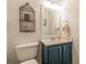 Half bathroom features a blue vanity and stylish birdcage decor at 4314 Arbor Bridge Ct, Marietta, GA 30066