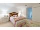 Bright bedroom with a wood headboard bed, flower rug, and neutral walls offering a cozy and inviting space at 4314 Arbor Bridge Ct, Marietta, GA 30066