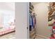 Bedroom featuring a walk-in closet, with wire shelving, hanging clothes, and assorted personal items at 4314 Arbor Bridge Ct, Marietta, GA 30066