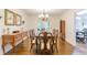 Formal dining room featuring hardwood floors, elegant lighting, and access to other rooms at 4314 Arbor Bridge Ct, Marietta, GA 30066