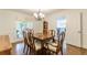Dining room with wood floors, a view to the kitchen, and access to the outside at 4314 Arbor Bridge Ct, Marietta, GA 30066