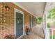 Brick front porch featuring a secure screened front door and painted white columns at 4314 Arbor Bridge Ct, Marietta, GA 30066