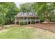 Charming brick home with a well-manicured lawn, mature trees, and a welcoming front porch at 4314 Arbor Bridge Ct, Marietta, GA 30066