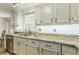 Bright kitchen featuring white cabinets, granite countertops, and stainless steel appliances at 4314 Arbor Bridge Ct, Marietta, GA 30066