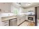 Bright kitchen featuring granite countertops, stainless steel appliances, and white cabinetry at 4314 Arbor Bridge Ct, Marietta, GA 30066