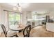 Kitchen with white cabinets, stainless appliances, and a breakfast table and chairs at 4314 Arbor Bridge Ct, Marietta, GA 30066
