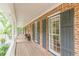 Long covered front porch featuring decorative columns, brick facade and dark green shutters at 4314 Arbor Bridge Ct, Marietta, GA 30066