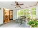 Inviting sunroom with ceiling fan, view of the backyard, and glass doors leading to the dining room at 4314 Arbor Bridge Ct, Marietta, GA 30066