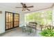 Inviting sunroom with ceiling fan, view of the backyard, and glass doors leading to the dining room at 4314 Arbor Bridge Ct, Marietta, GA 30066