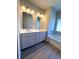 Bright bathroom featuring a double vanity with a white countertop and stylish lighting fixtures at 5726 Silver Lake Dr, Mableton, GA 30126