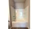 Bathroom featuring a bathtub and shower with white tile surround at 5726 Silver Lake Dr, Mableton, GA 30126