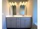 Bathroom boasts double sinks, white cabinets, a luxurious soaking tub, and bright vanity lighting at 5726 Silver Lake Dr, Mableton, GA 30126