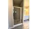 Walk-in shower featuring stylish grey tile, a glass door, and modern fixtures at 5726 Silver Lake Dr, Mableton, GA 30126