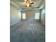 This main bedroom is spacious and features a tray ceiling, ceiling fan, and multiple windows for natural light at 5726 Silver Lake Dr, Mableton, GA 30126