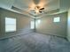 This main bedroom is spacious and features a tray ceiling, ceiling fan, and multiple windows for natural light at 5726 Silver Lake Dr, Mableton, GA 30126