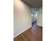 Hallway with sleek wood floors leading to the open-concept living spaces at 5726 Silver Lake Dr, Mableton, GA 30126