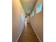 Long, bright hallway with wood floors, leading to a white entry door at 5726 Silver Lake Dr, Mableton, GA 30126