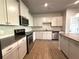 Well-lit kitchen features granite countertops, stainless steel appliances, and ample cabinet space at 5726 Silver Lake Dr, Mableton, GA 30126