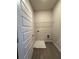 This laundry room is equipped with a washing machine, dryer hookups, and sleek wood floors at 5726 Silver Lake Dr, Mableton, GA 30126