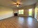 Open concept living room with fireplace, fan, and natural light at 5726 Silver Lake Dr, Mableton, GA 30126