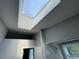 Bright bathroom with a skylight above the shower with white tile and decorative black border and a window for natural light at 6325 Stablewood Way, Lithonia, GA 30058