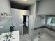 Bright bathroom features a sleek vanity, a tiled shower-tub combo, and lots of natural light at 6325 Stablewood Way, Lithonia, GA 30058