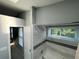 Bright bathroom features a shower with white tile and decorative black border and a window for natural light at 6325 Stablewood Way, Lithonia, GA 30058