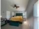 Spacious bedroom features a large bed with dark green headboard and ceiling fan at 6325 Stablewood Way, Lithonia, GA 30058